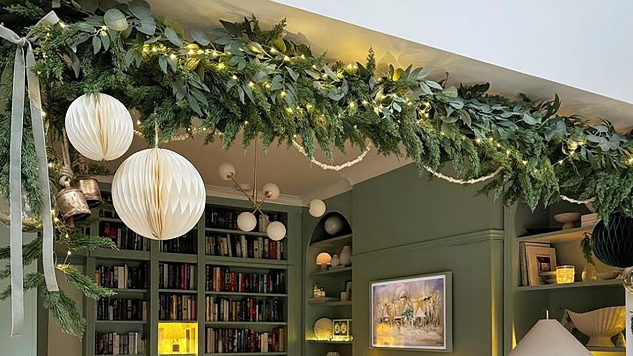 Christmas garland in living room with built-in bookshelves.