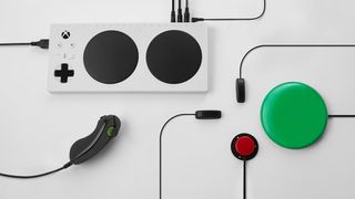 The Mirosoft Xbox Adaptive Controller plugged into some of the buttons and toggles it's compatible with
