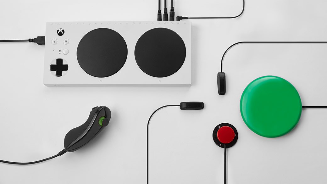The Mirosoft Xbox Adaptive Controller plugged into some compatible devices