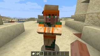 Minecraft villagers - A villager stands in a desert biome wearing orange and green clothes.