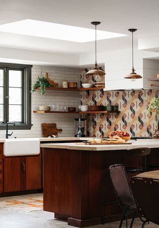 kitchen with reclaimed tiled backsplash and wooden cabinetry