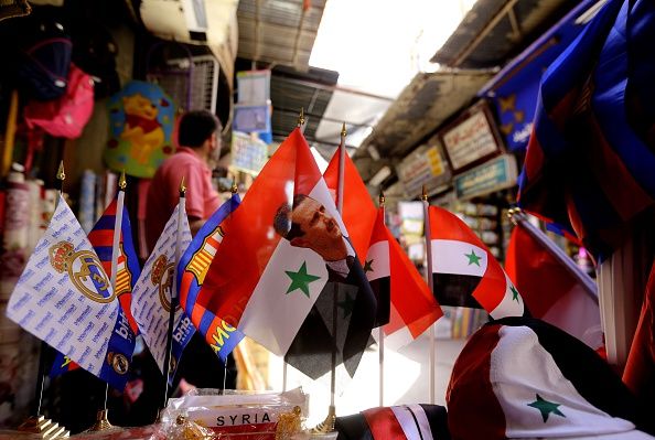 A Syrian flags with a picture of President Bashar al-Assad.