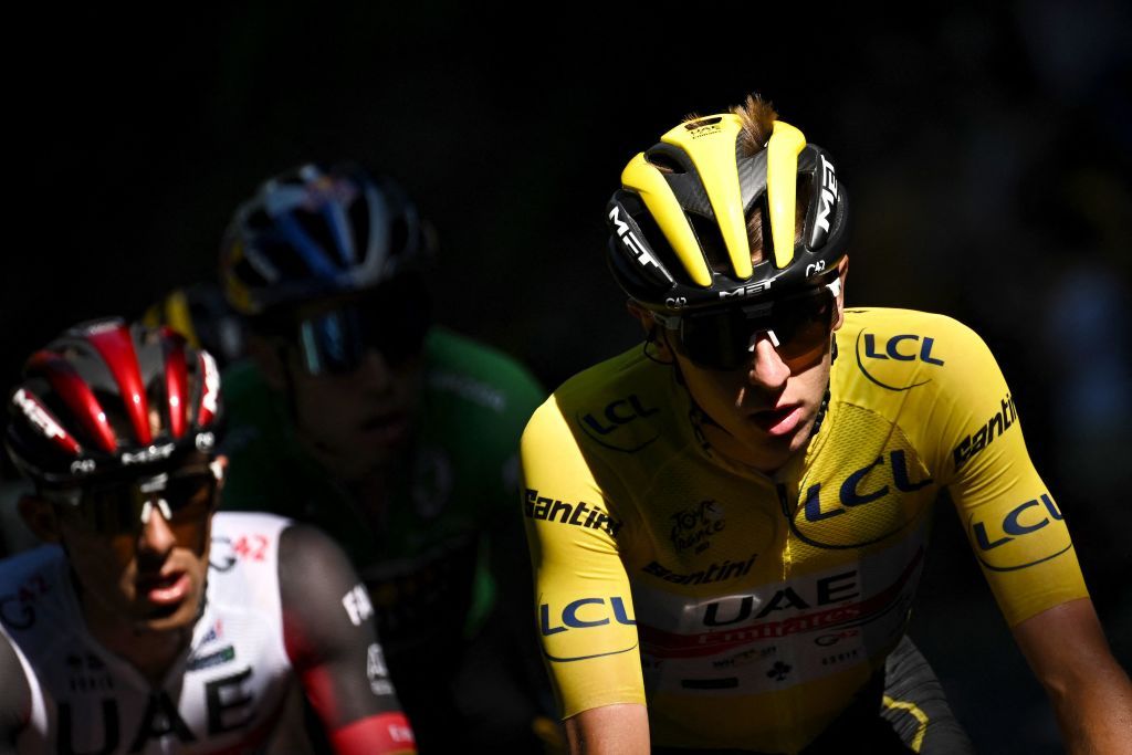 UAE Team Emirates teams Slovenian rider Tadej Pogacar wearing the overall leaders yellow jersey R cycles with the pack of riders during the 10th stage of the 109th edition of the Tour de France cycling race 1481 km between Morzine and Megeve in the French Alps on July 12 2022 Photo by Marco BERTORELLO AFP Photo by MARCO BERTORELLOAFP via Getty Images
