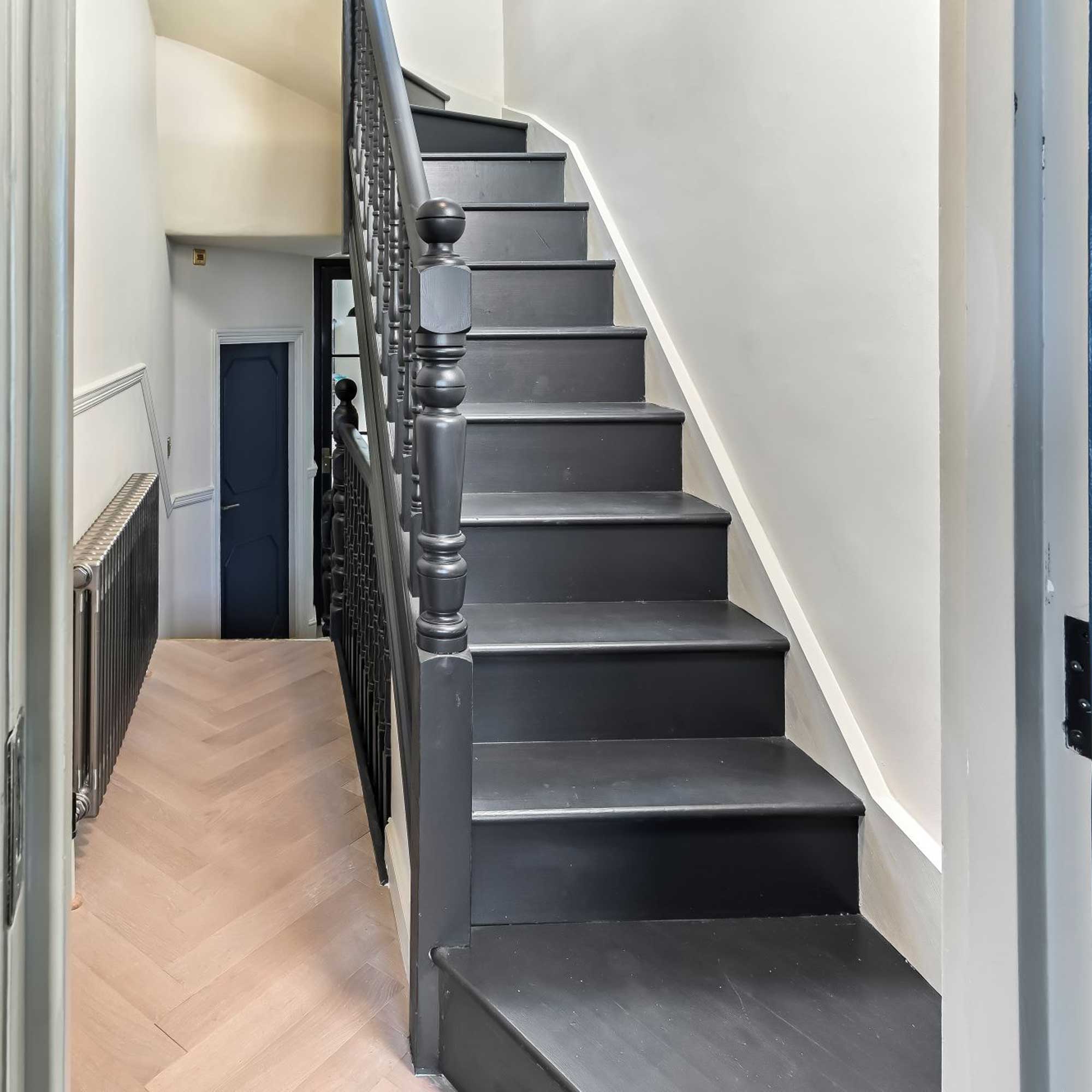black staircase leading to loft conversion
