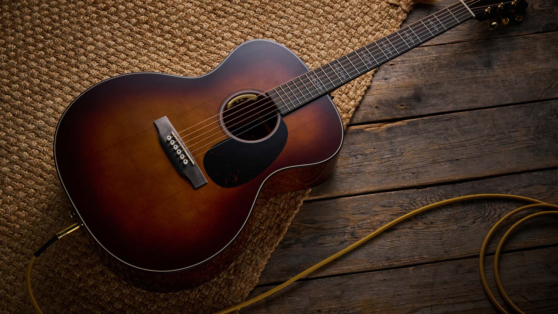 Martin GPE Inception Maple photographed against a wheat coloured woven rug.