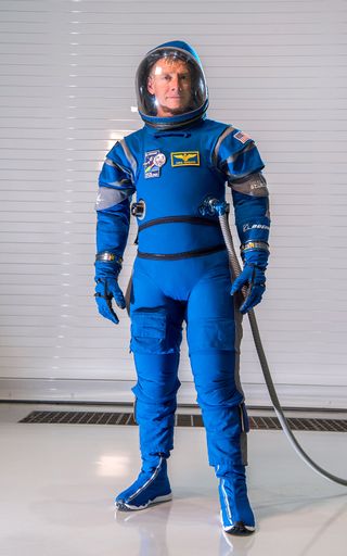 astronaut wearing boeing spacesuit while standing