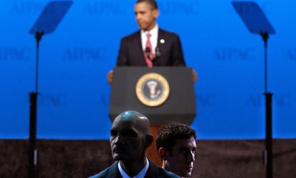 Secret Service agents watch the audience while President Obama speaks in March 2012.