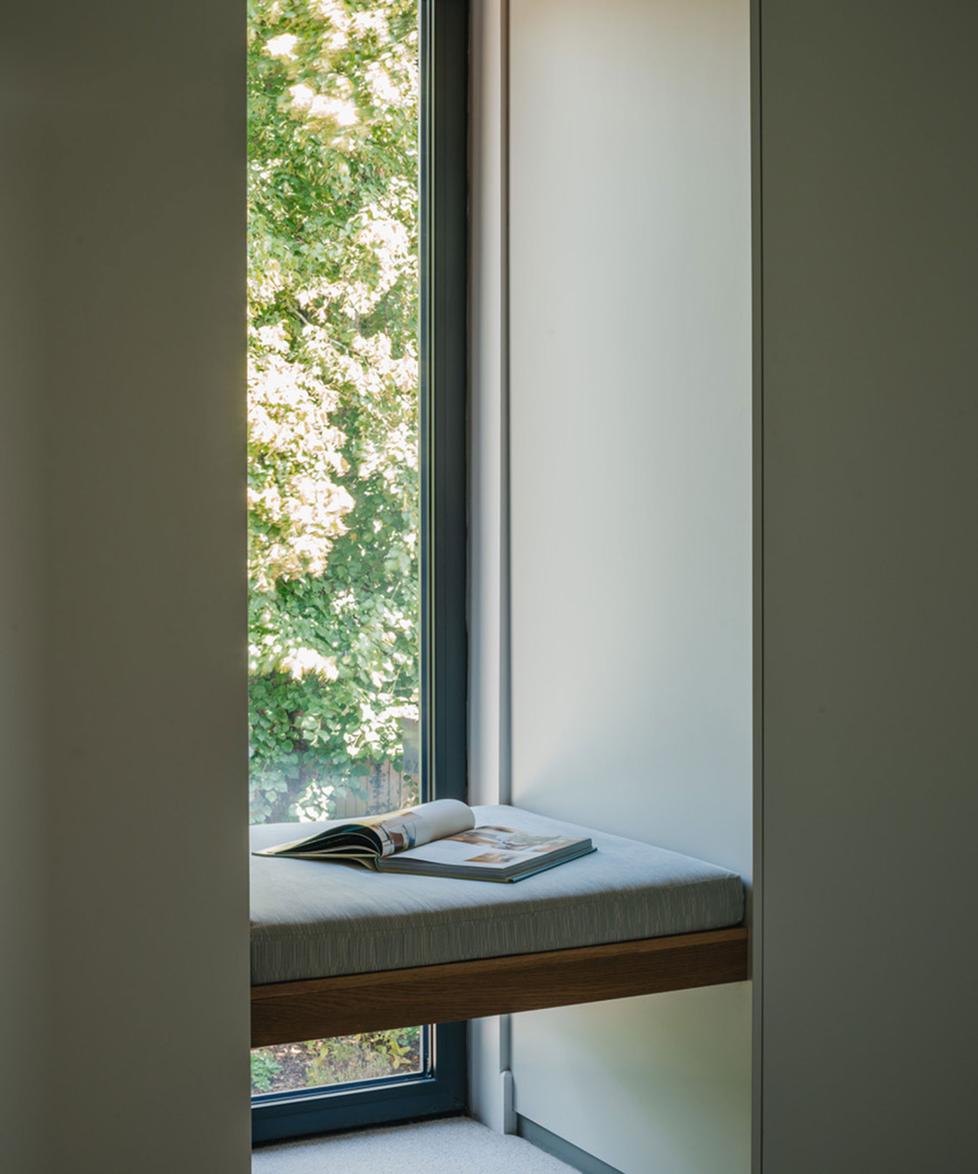 Narrow vertical slot window with window seat