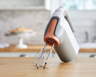 Breville HeatSoft electric whisk hand mixer on wooden kitchen countertop