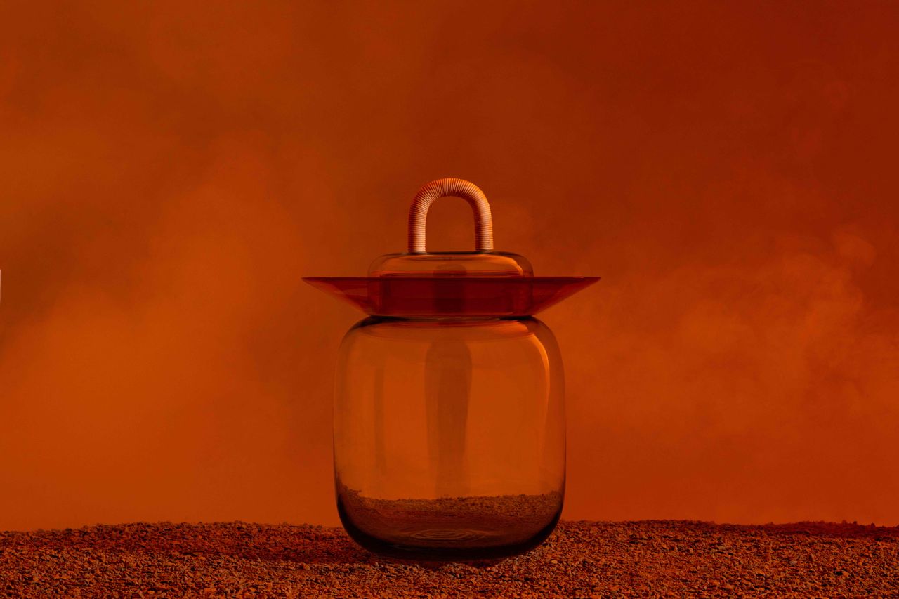 glass fermentation jar on orange backdrop
