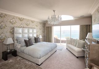 bedroom with table lamp and chandelier