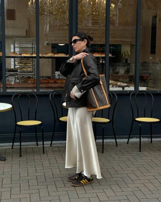 Classic trainer outfits: @francescasaffari wears a biker jacket, skirt and trainers