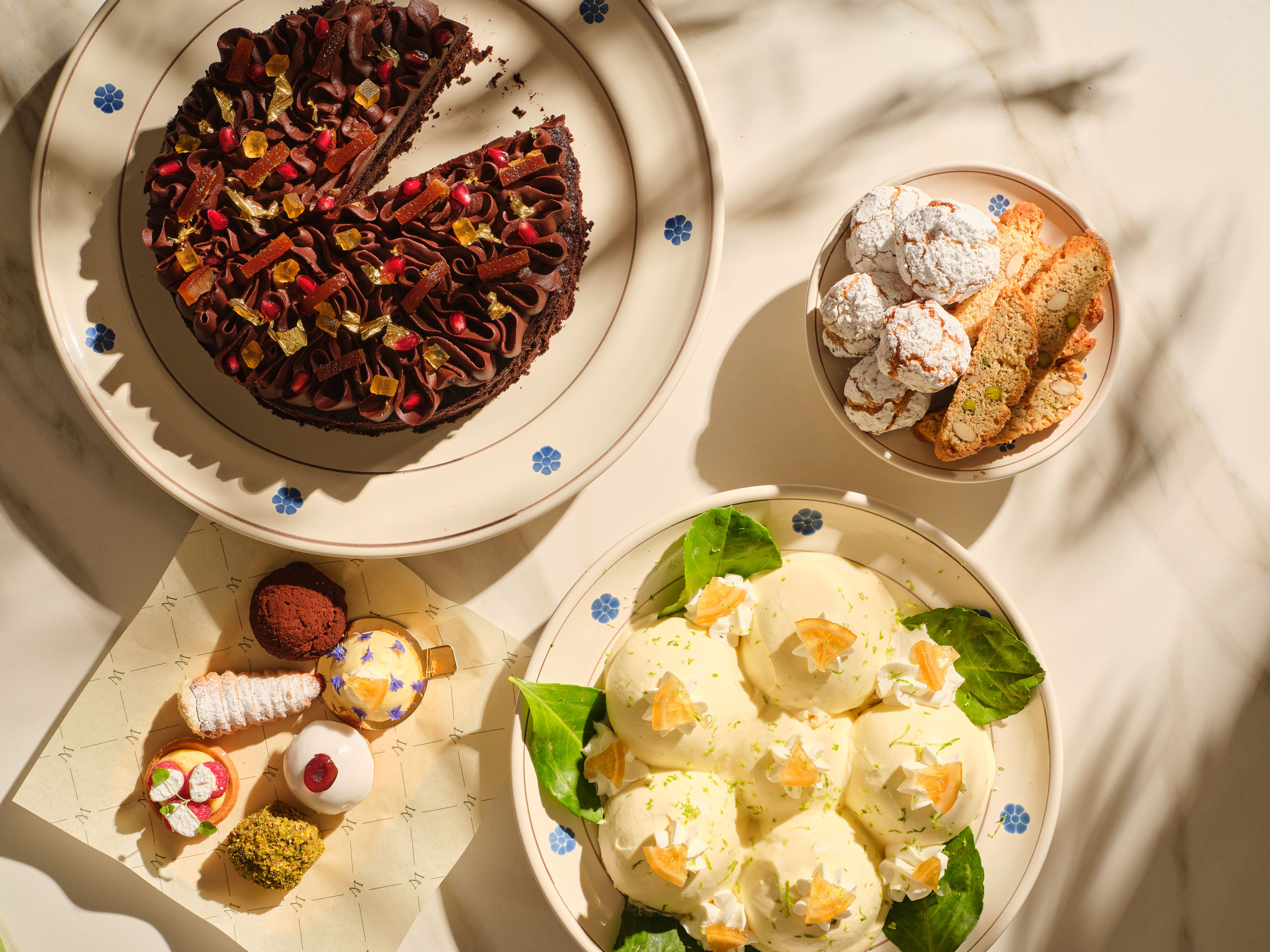 photo of sample dishes at Mezzogiorno restaurant shot from above, lush warm italian past and cakes