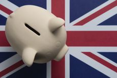 Piggy bank on Union Jack flag, signifying NS&I's British Savings Bonds