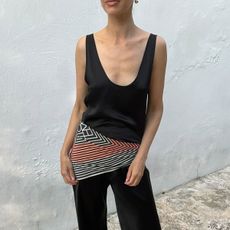 Woman in black outfit and silk scarf belt