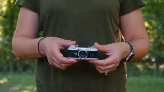 The Instax Pal 2 in a photographer's hands