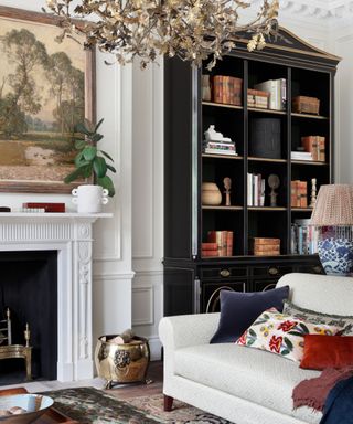 White living room with dark build in bookshelves