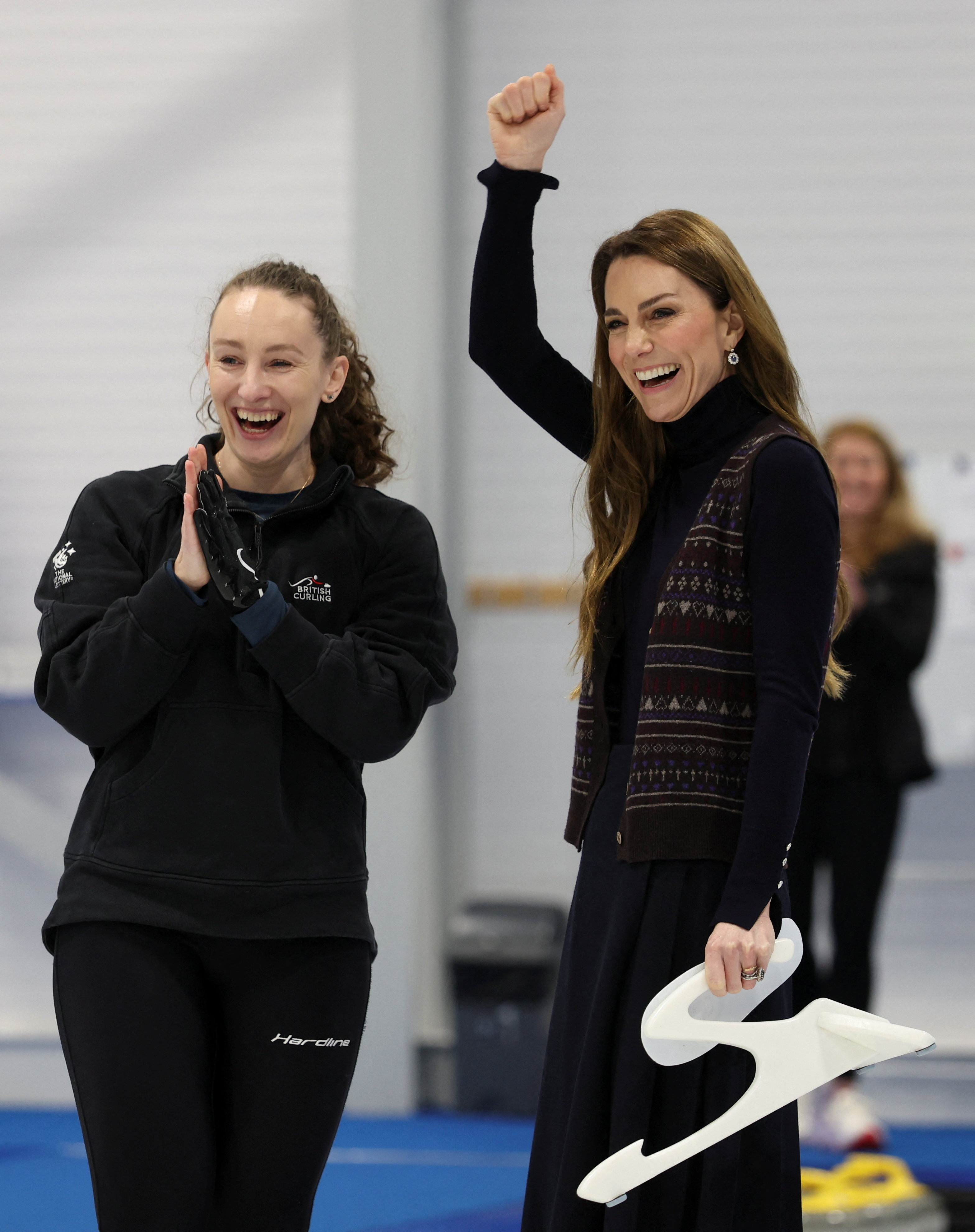 Princess Kate raising her arm in the air while curling