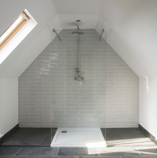 grey walk in shower in vaulted ceiling bathroom
