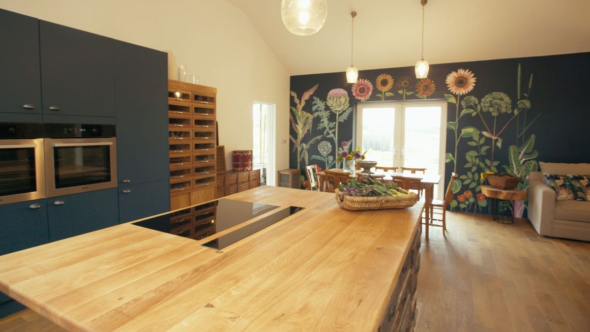 Natural lighting shines into newly built kitchen, unveiling all the kitchen amenities such as the oak kitchen island.