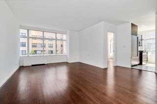 An empty room in an apartment with white walls and wooden floors