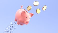 A piggy bank appears to bounce off of a spring into the air as gold coins fly out of it.