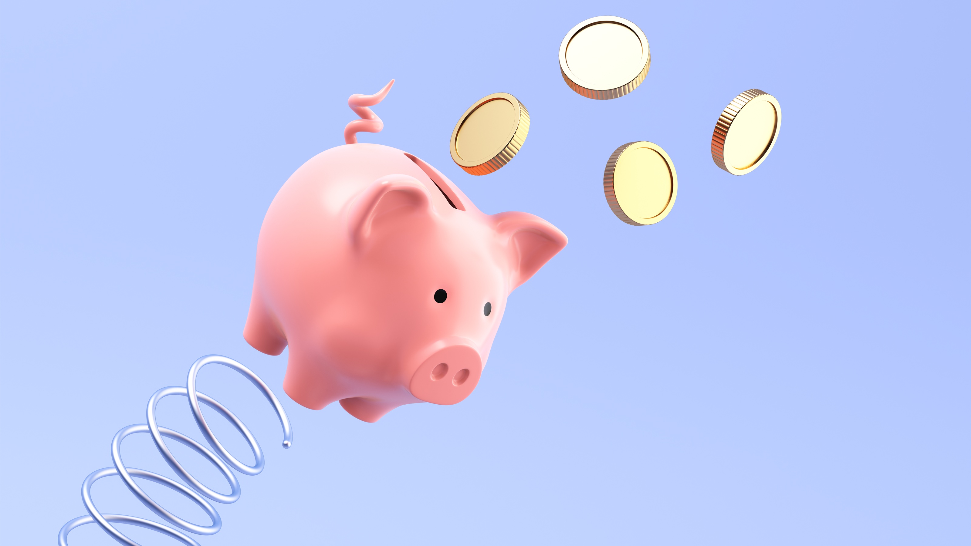 A piggy bank appears to bounce off of a spring into the air as gold coins fly out of it.