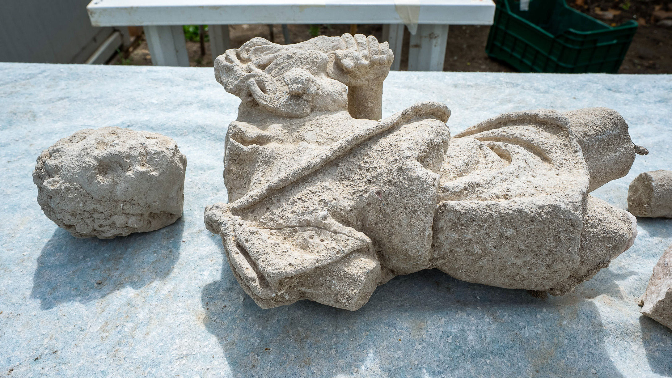 archaeologists work at an ancient Roman site revealing mosaic floors and frescoed walls of a villa