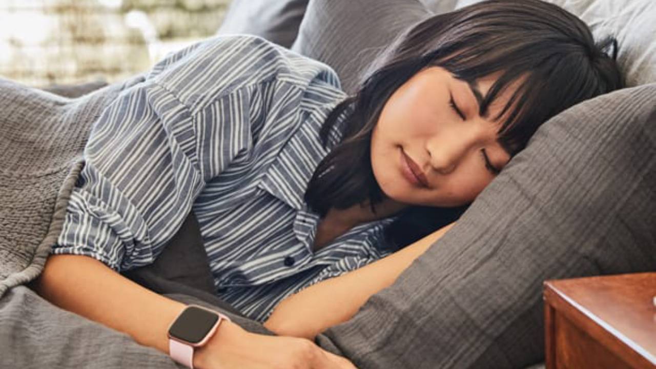 Woman asleep wearing a sleep tracker