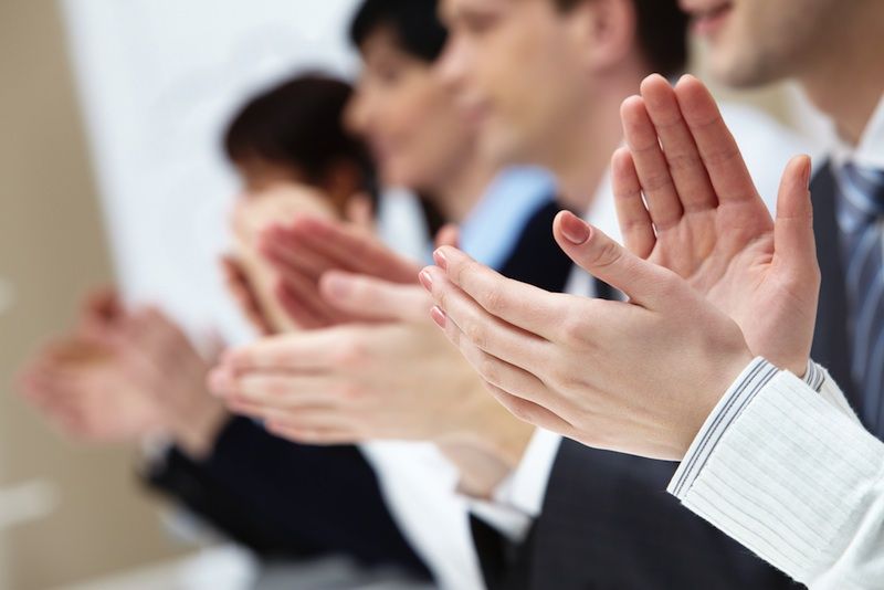 A group of people clapping