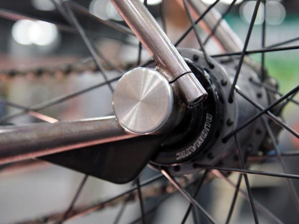 The rear dropout on Naked's city bike very cleanly incorporates an eccentric to tension the chain.