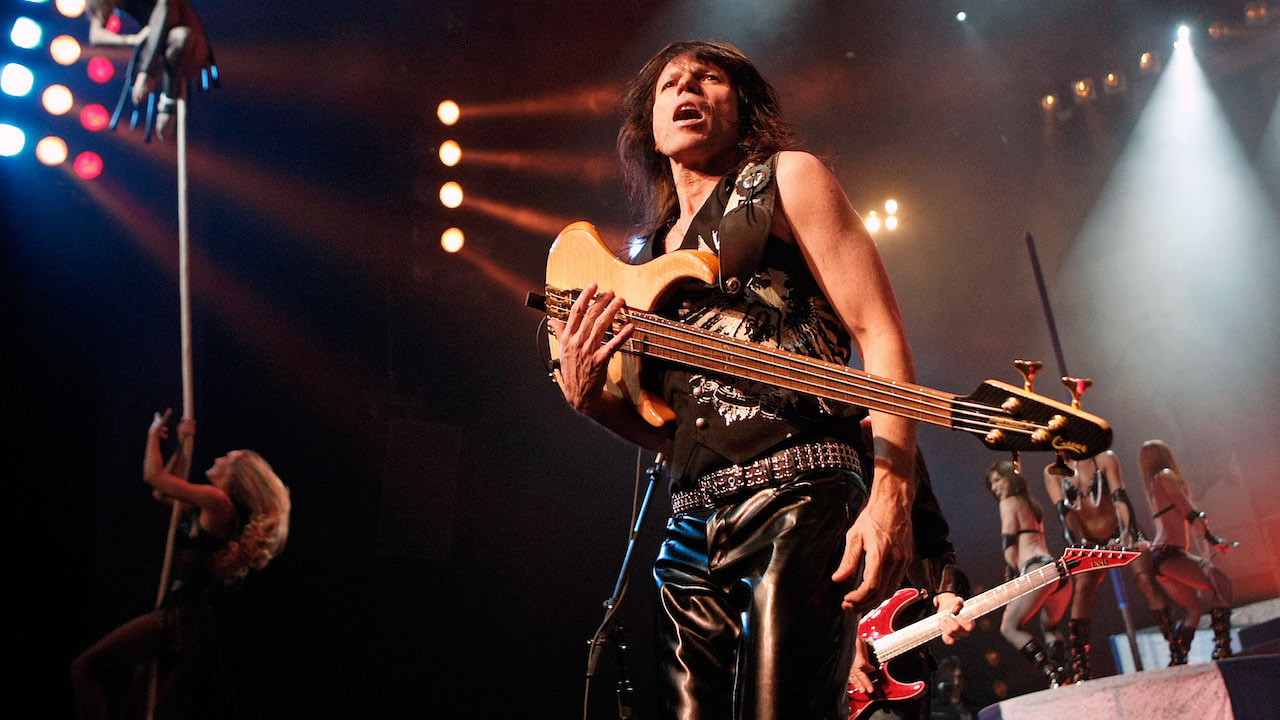 Bassist Rudy Sarzo performs with aerialists and dancers at the Monster Circus show at the Las Vegas Hilton early March 27, 2009 in Las Vegas, Nevada. The show combines a concert featuring veteran rock stars performing hit songs from the '70s, '80s and '90s with dancers, aerialists and circus acts.