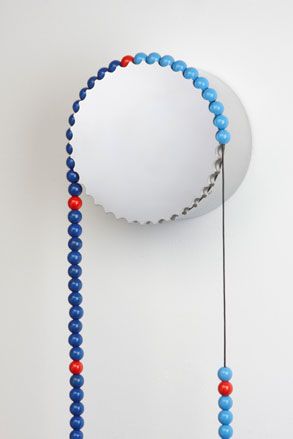 Sasa Clock' comprises painted-wood beads hung over a slowly turning carousel
