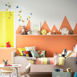 kids room with orange and white painted shapes on wall