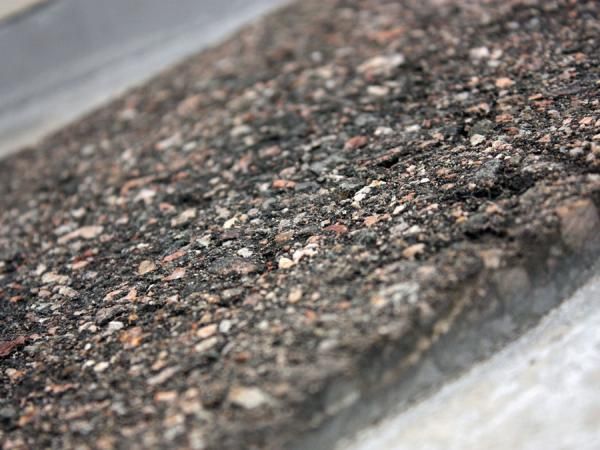 Slick treads maximize the surface contact area of road tyres on the pavement in theory but in reality, asphalt is far from a perfect surface and tread designs can offer additional mechanical adhesion in certain situations.