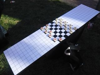 Seesaw with a grid-lined surface with a Chinese chessboard in the middle