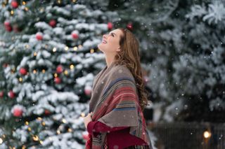 Brooke Shields stands looking up at the snow in 'A Castle for Christmas'