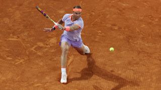 Rafa Nadal plays a shot on clay court
