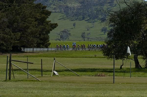 Riders make their way past the oldest golf club in the Southern Hemisphere at Bothwell where fences are erected around the greens to deter grazing sheep.