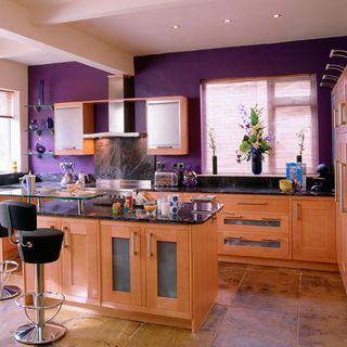 kitchen room with tiled flooring and purple wall