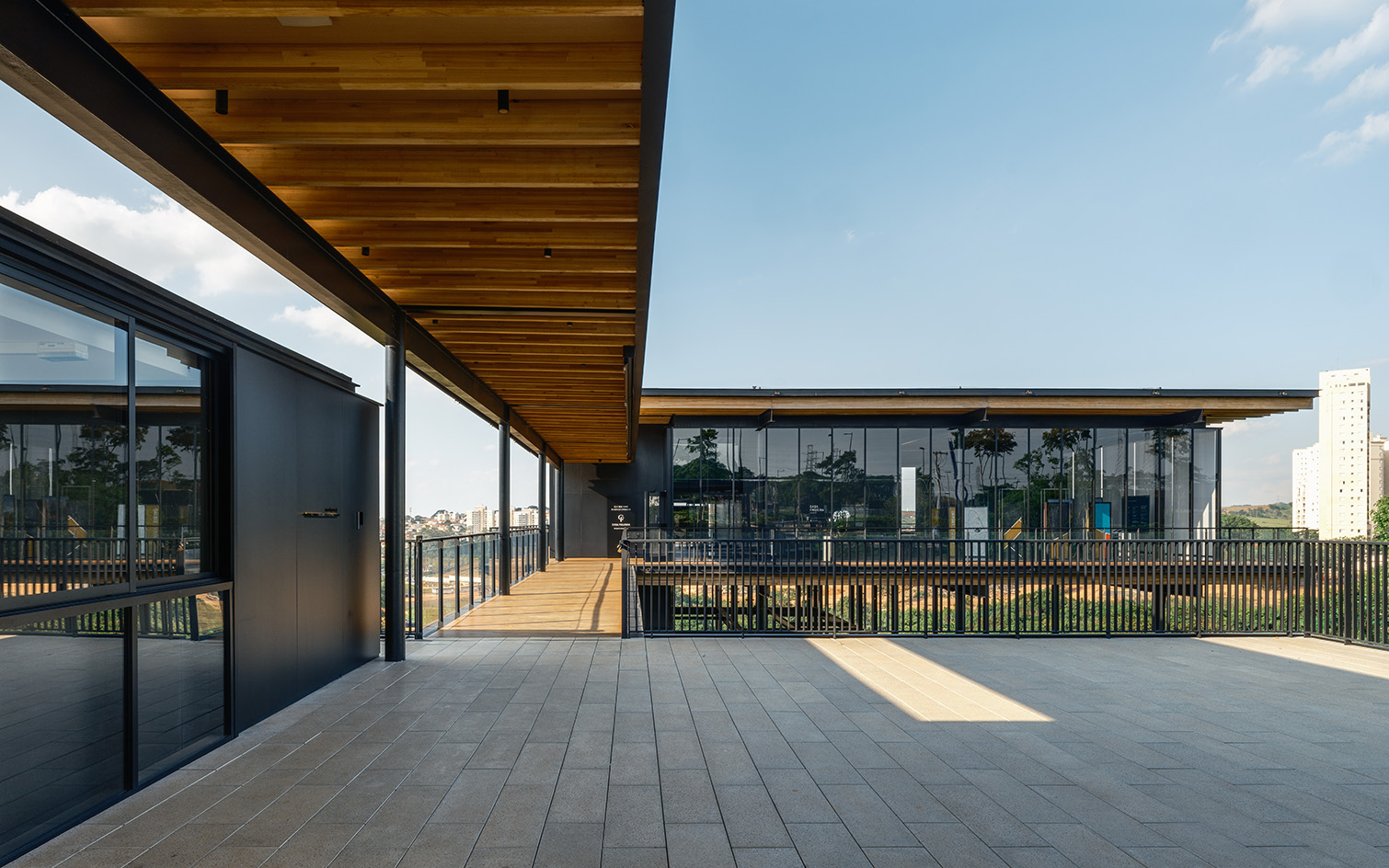 Casa Figueira, Sao Paulo, a light structure, floating above green tree canopies, a pavilion-like showroom