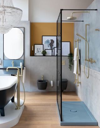 A bathroom featuring a black free-standing tub, a walk in shower, and a large chandelier