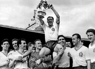 Nat Lofthouse lifts the FA Cup after Bolton Wanderers' win over Manchester United in the 1958 final.