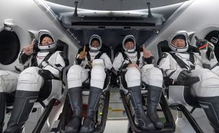 From left, NASA astronauts Shannon Walker, Victor Glover and Mike Hopkins, and Japan Aerospace Exploration Agency (JAXA) astronaut Soichi Noguchi are seen inside the SpaceX Crew Dragon "Resilience" spacecraft on board the SpaceX GO Navigator recovery ship shortly after splashing down in the Gulf of Mexico off the coast of Panama City, Florida, on May 2, 2021.