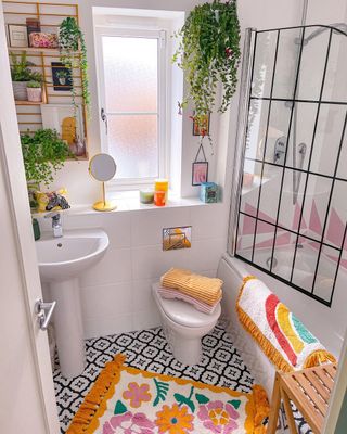 A colorful bathroom with a floral bathmat