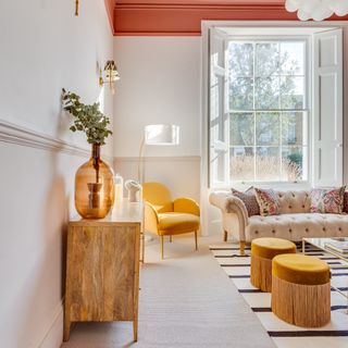 Neutral living room with orange-pink pops of colours