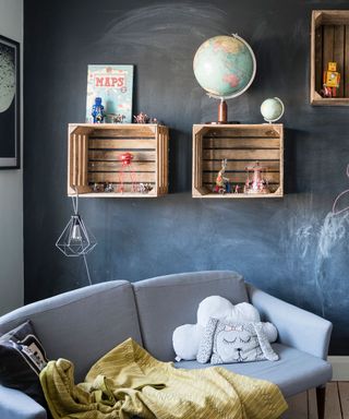 children room with black board and wooden flooring