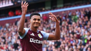 Ollie Watkins celebrates a goal in his claret and blue Aston Villa shirt.