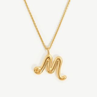 flat lay image of M initial necklace