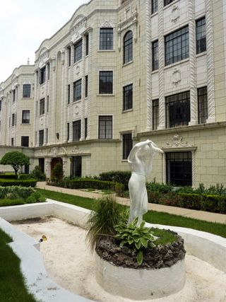 White statue within green garden